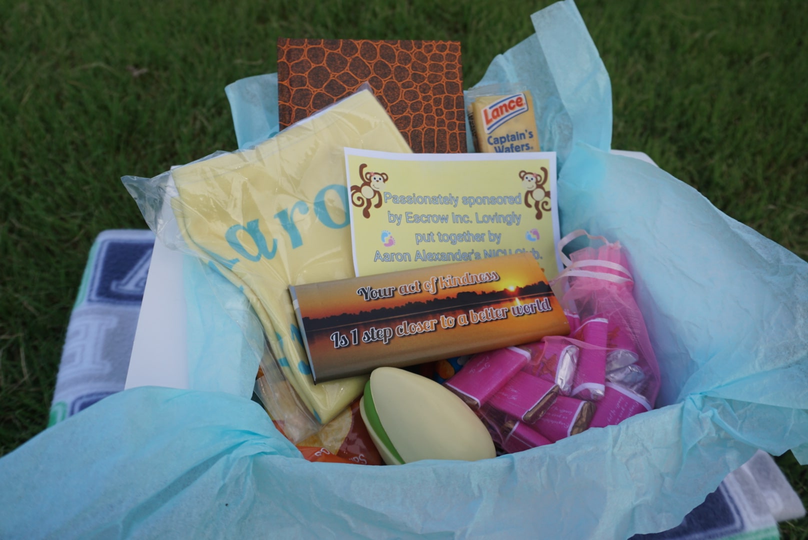 Care package with baby necessities and an Aaron Alexander NICU Club card